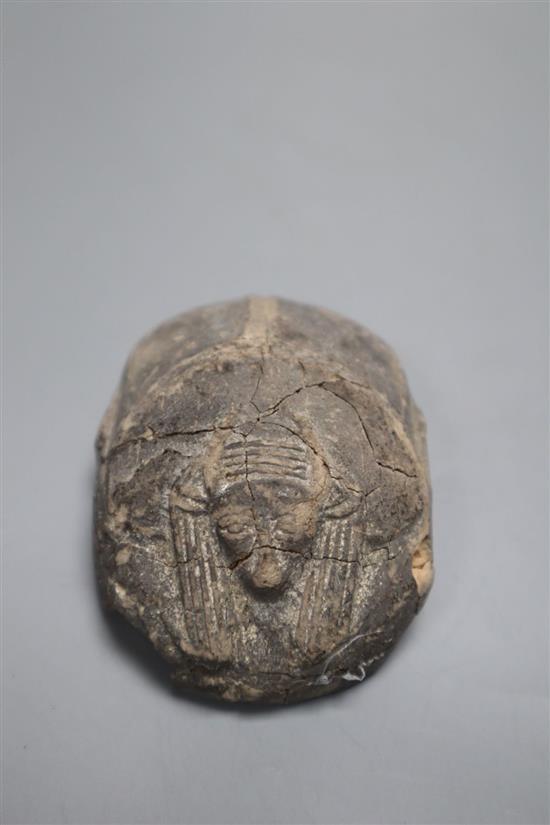 An ancient Egyptian pottery scarab beetle, with hieroglyphic inscriptions length 7.5cm